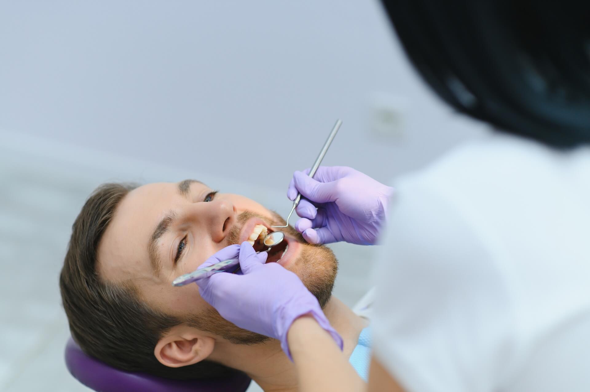 medium-vecteezy_periodontal-services-closeup-shot-of-smiling-man-getting_48226763_medium (1)